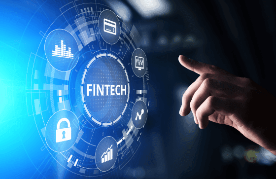 A digital interface displaying the word "FINTECH" surrounded by icons representing security, analytics, transactions, and global payments, with a hand reaching toward the screen—symbolizing innovative financial technology solutions.