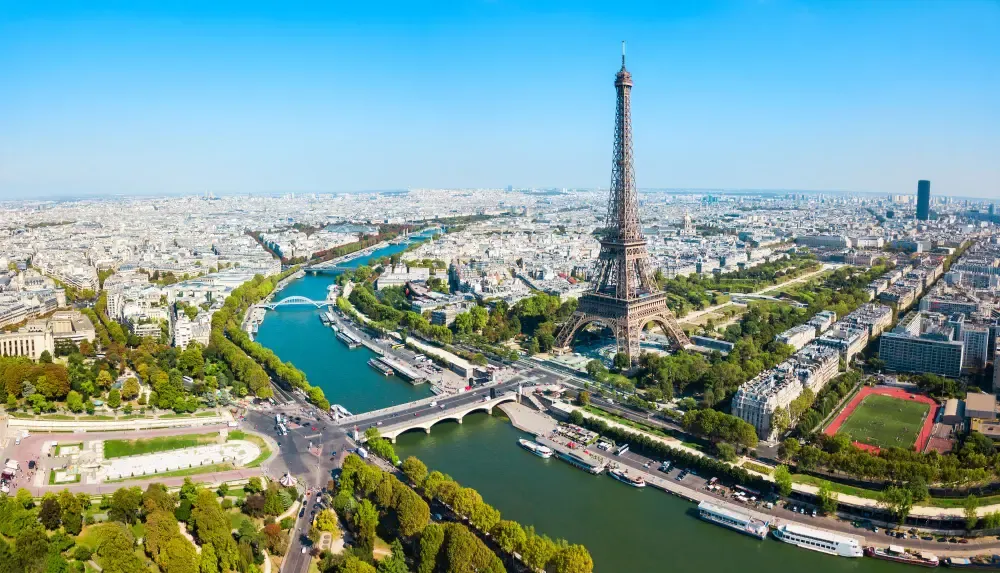 Aerial view of the Eiffel Tower in Paris with the Seine River below. Canadian students can transfer tuition payments in EUR to France at low cost using MTFX's secure online platform.