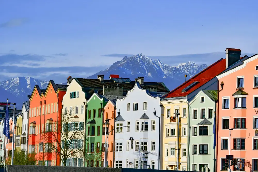 Colourful houses in Innsbruck with the Austrian, offering Canadian students an inspiring study environment in the heart of the Tyrol region. Explore low-cost CAD to EUR transfer options for tuition.