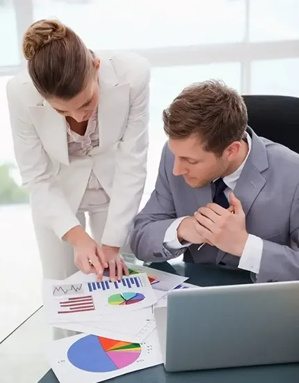 Businesswoman explaining charts and graphs to a colleague during a financial discussion