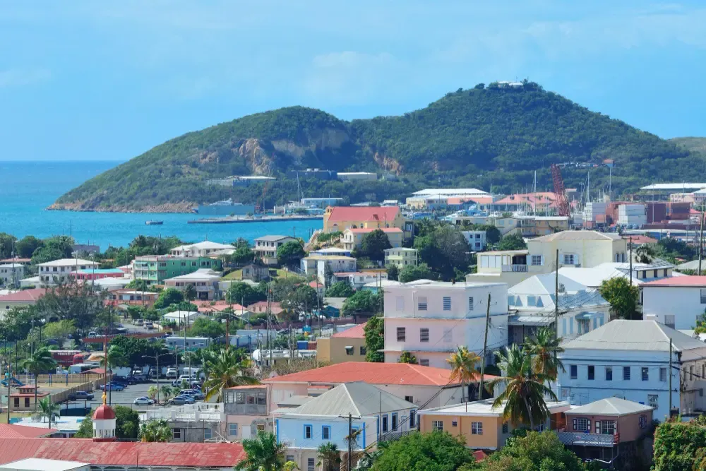 Scenic view of St. George’s, Grenada,A vibrant tropical town with colorful architecture nestled between lush green hills and the sea