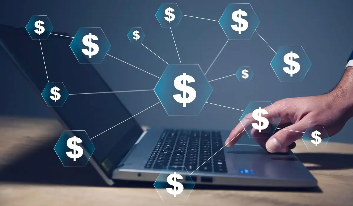 Person using a laptop with digital dollar icons overlay, symbolizing online payments, currency exchange, and cross-border money transfers for businesses.