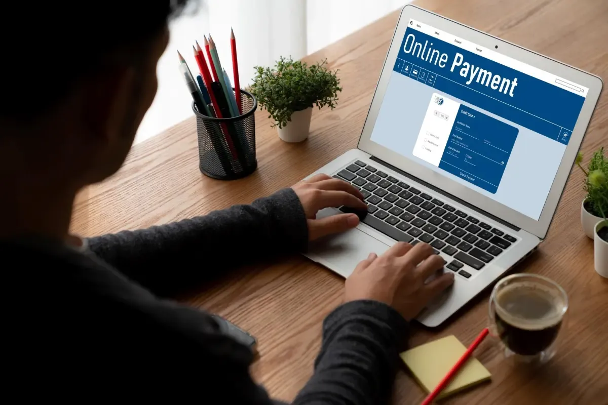 Business user making an online payment on a laptop, representing digital international payments and global invoice processing for businesses