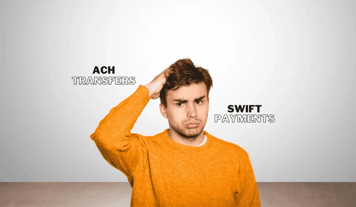 Confused man scratching his head, standing between the terms 'ACH Transfers' and 'SWIFT Payments,' representing confusion and uncertainty about international payment methods.