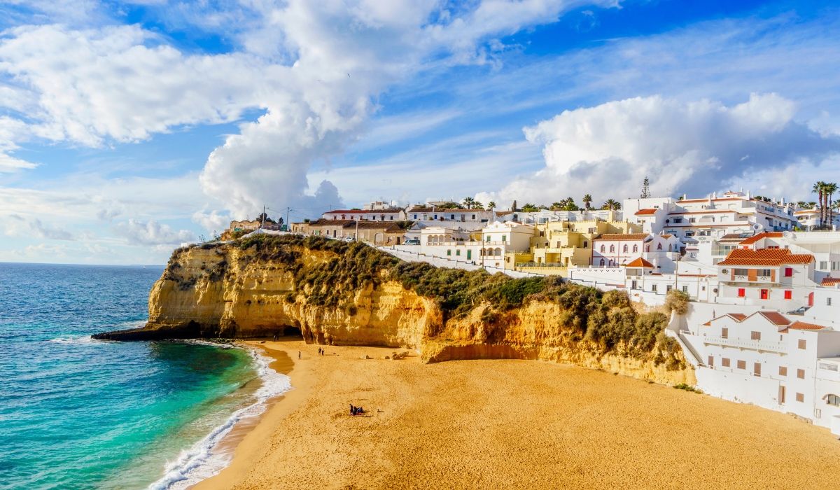 Golden cliffs and whitewashed homes along the sandy beaches of Algarve, Portugal