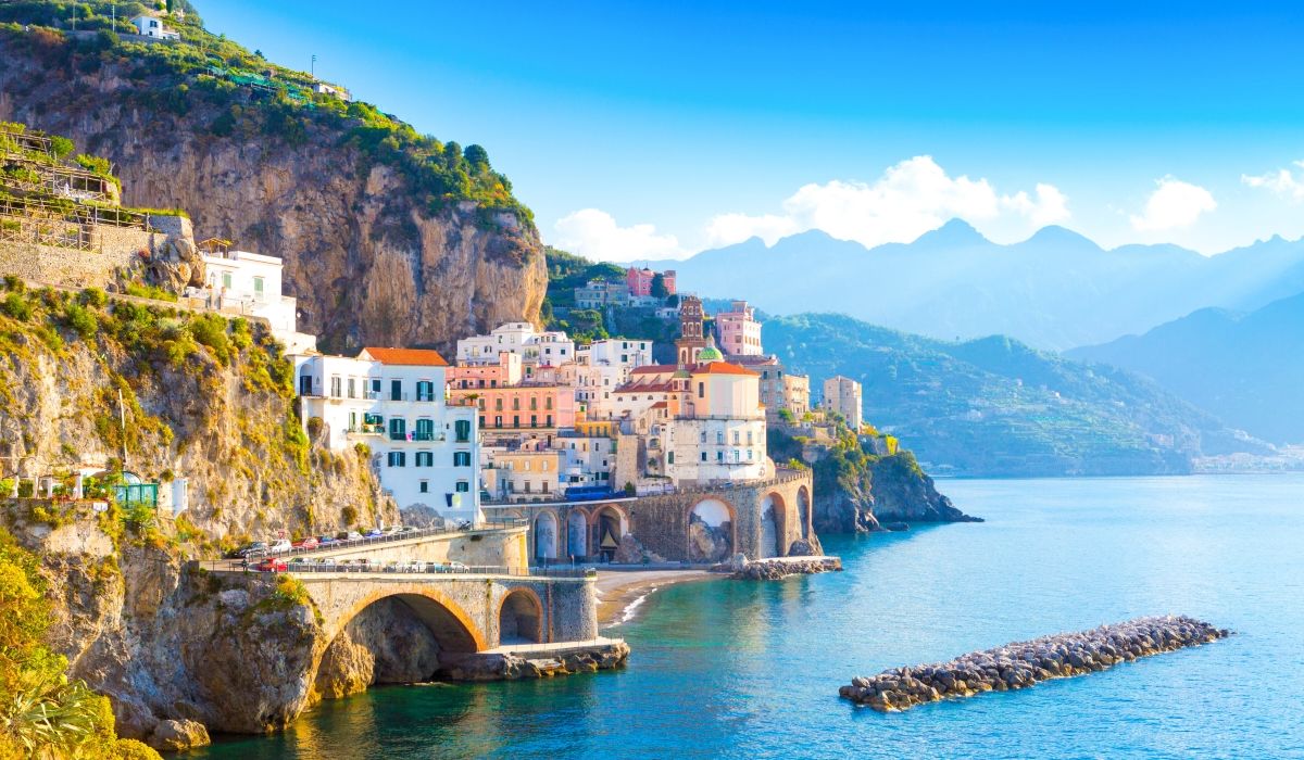 A dramatic cliffside village on Italy’s Amalfi Coast, with colorful buildings cascading down to the sea.