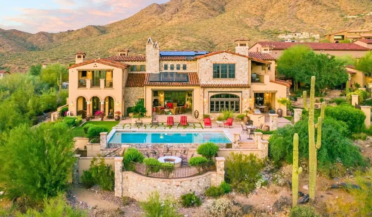 Luxury Arizona villa surrounded by desert mountains, symbolizing Canadians converting CAD to USD for high-value US property purchases and saving on foreign exchange costs.