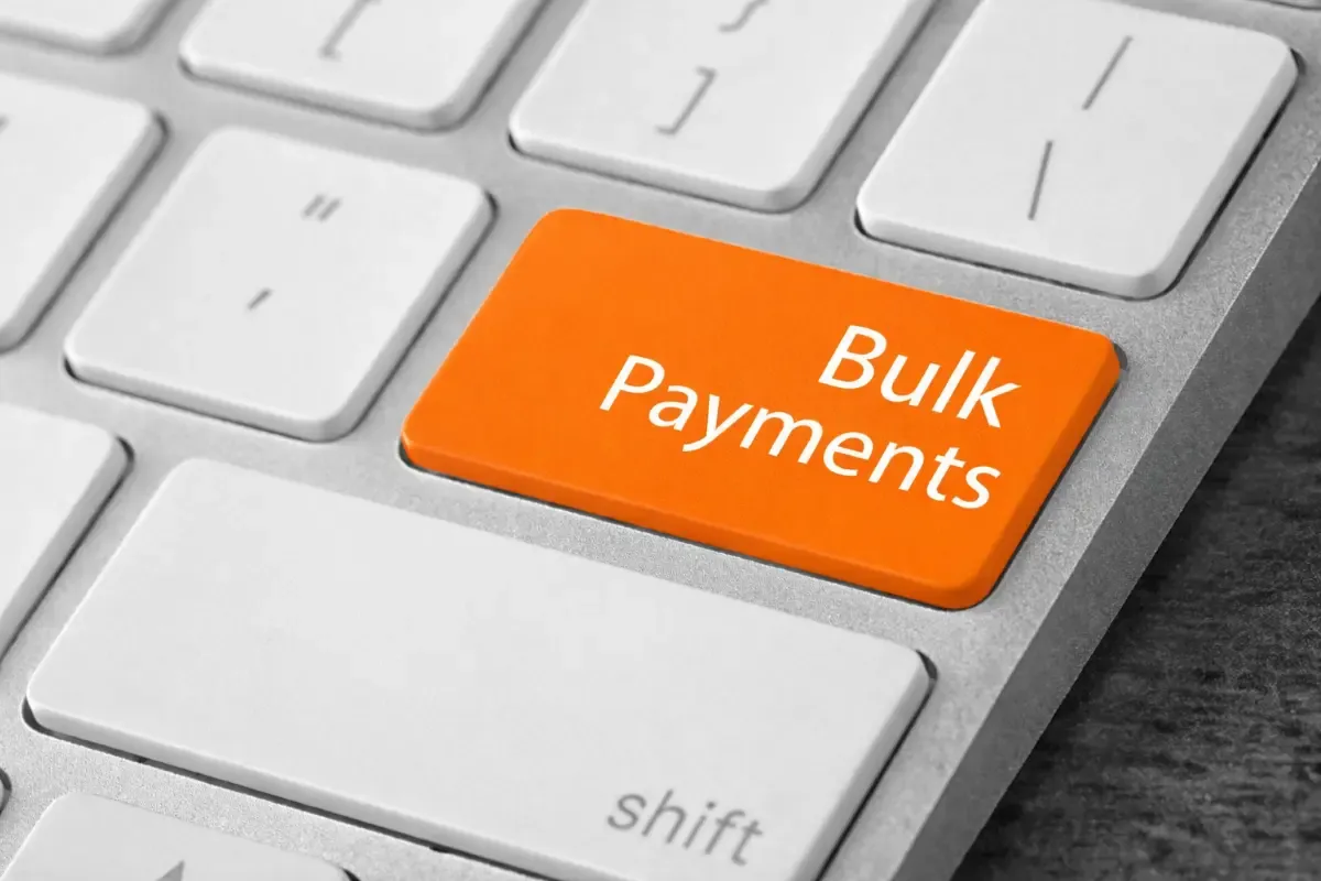 Close-up of keyboard with orange bulk payments key representing fast and efficient digital payment processing