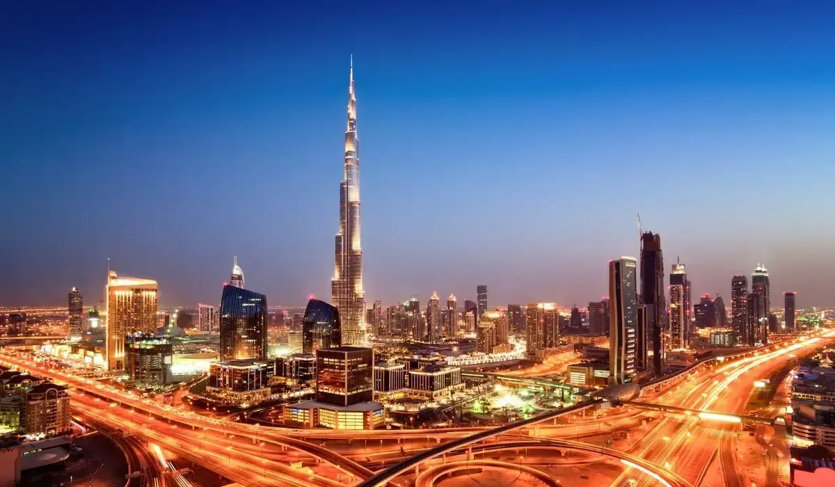 Panoramic view of downtown Dubai with Burj Khalifa illuminated at dusk, showcasing the city’s modern skyline and vibrant infrastructure.