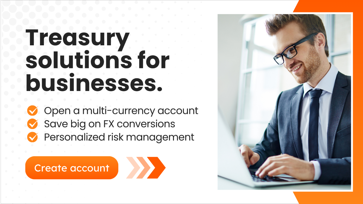 A promotional digital banner featuring a smiling businessman in a suit and glasses working on a laptop. The text reads "Treasury solutions for businesses." followed by bullet points listing benefits such as opening a multi-currency account, saving on FX conversions, and personalized risk management. An orange "Create account" button is at the bottom.