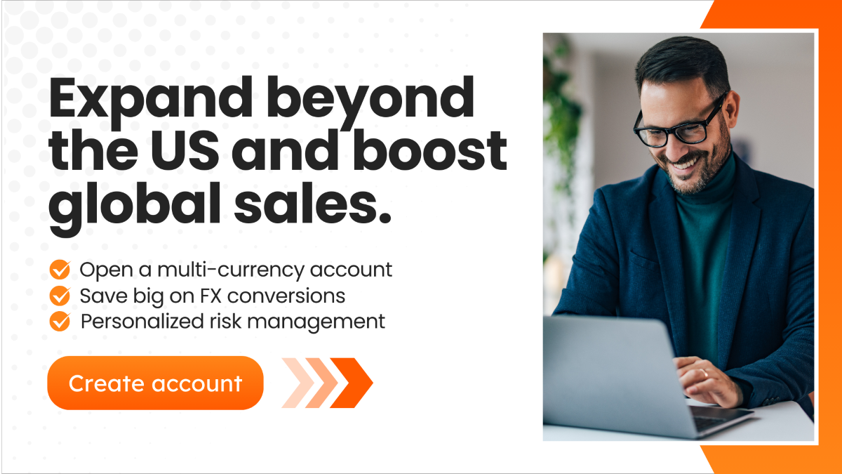 A digital ad featuring a smiling businessman in glasses working on a laptop. The bold text reads 'Expand beyond the US and boost global sales,' followed by a list of benefits such as multi-currency accounts and FX conversions. There is an orange button labeled 'Create account' with arrow graphics.