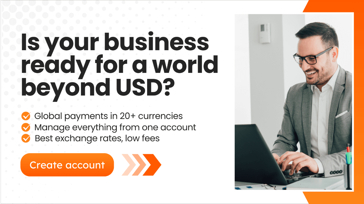 A business professional smiling while working on a laptop, with text overlay promoting global payments in 20+ currencies and low fees with MTFX.