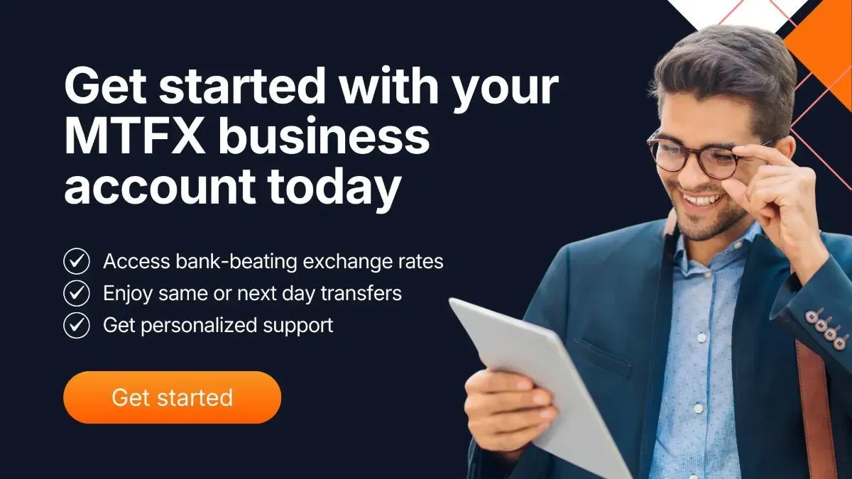Smiling business professional using a tablet beside a banner promoting MTFX business accounts with features like bank-beating rates, fast transfers and personalized support.