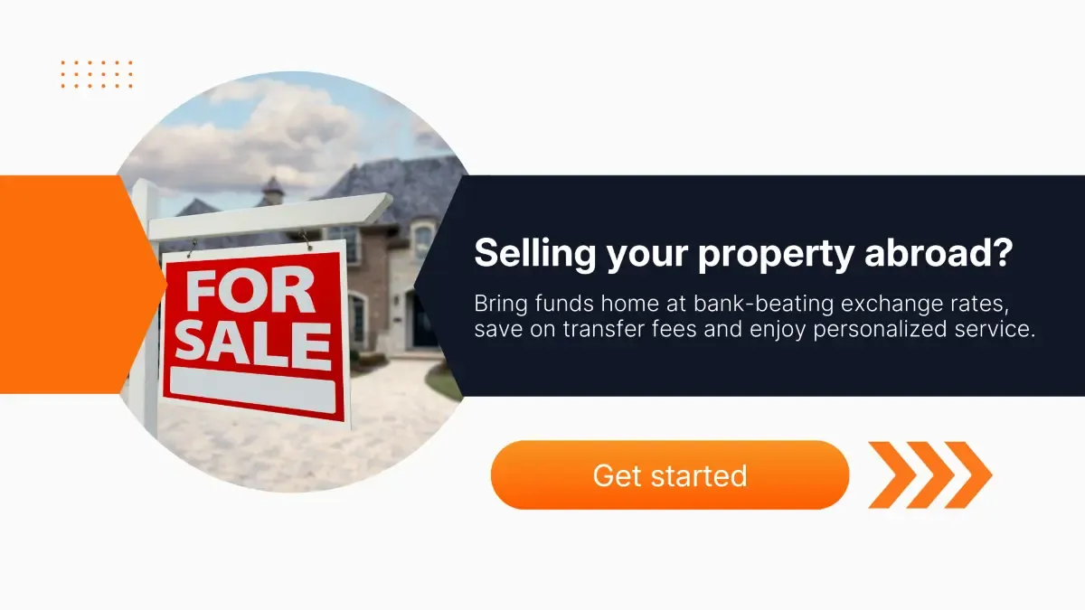 For sale sign in front of house illustrating selling property abroad and transferring funds internationally