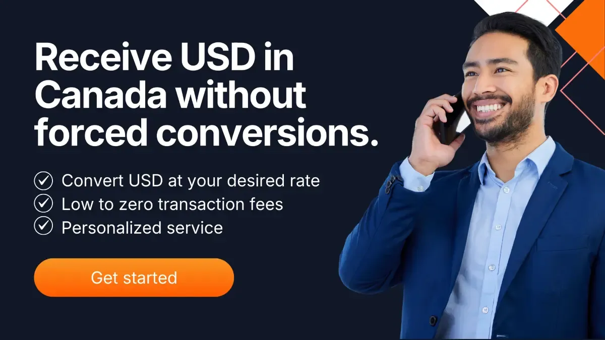 Business professional speaking on a smartphone beside a banner promoting receiving USD in Canada without forced currency conversion, highlighting low transaction fees and personalized service.