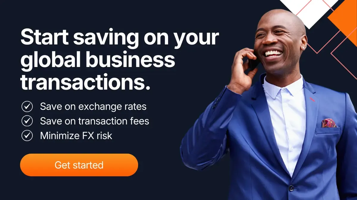 Business professional smiling while speaking on a phone representing global business payments and international transactions.