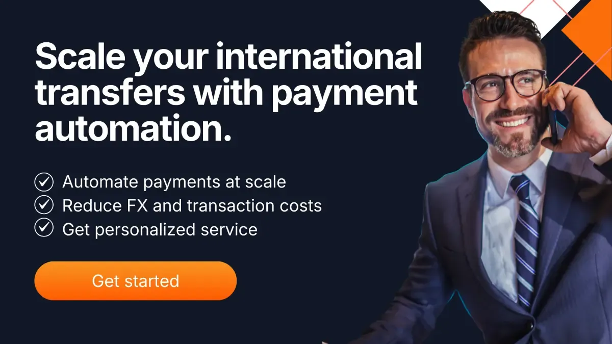 Business professional in suit using smartphone with headline about scaling international transfers through payment automation, highlighting automated payments, reduced FX costs, and personalized service.