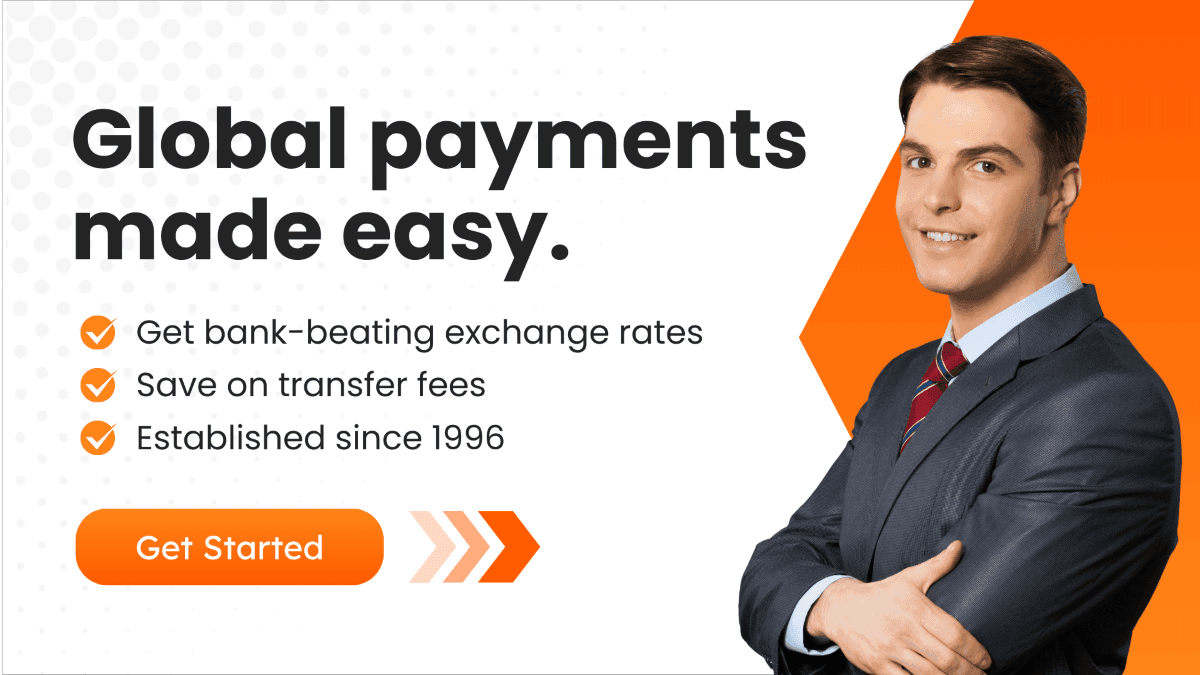 Professional businessman smiling in front of a banner offering global payment solutions with bank-beating exchange rates and low transfer fees.