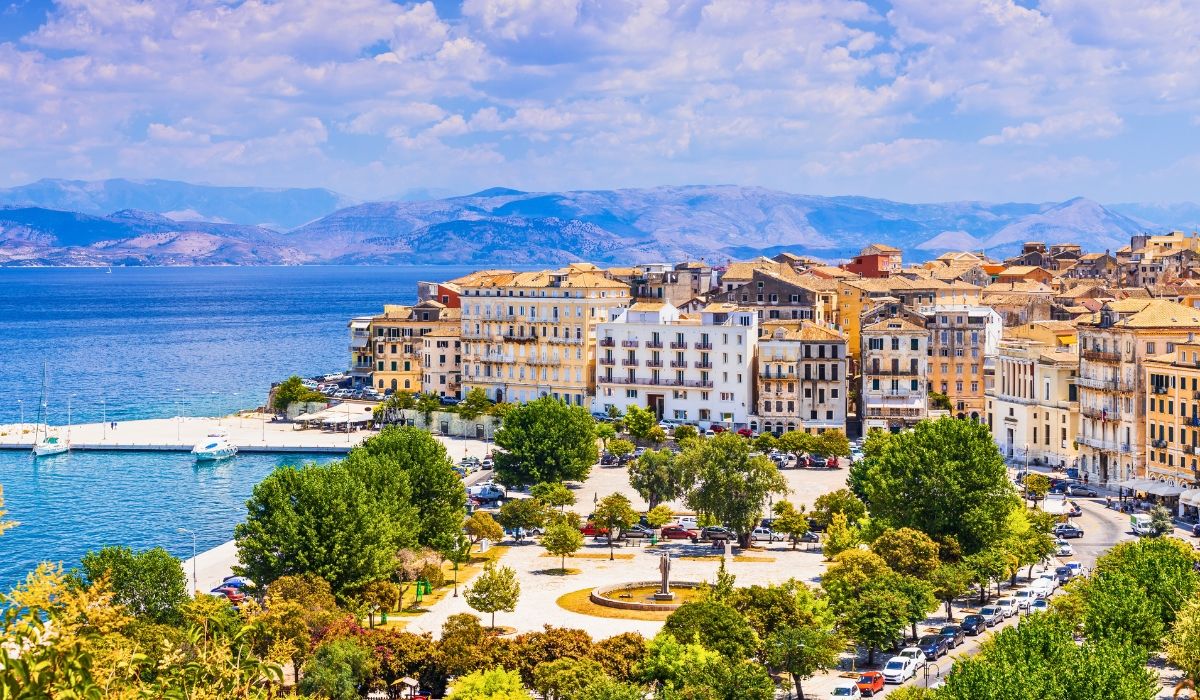 Vibrant Corfu town with historic buildings and Ionian Sea backdrop.