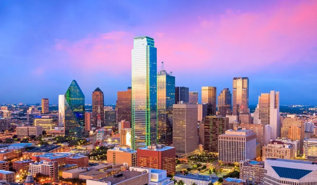 An aerial view of downtown Dallas, Texas, displaying the city's prominent skyscrapers and urban landscape during daylight.