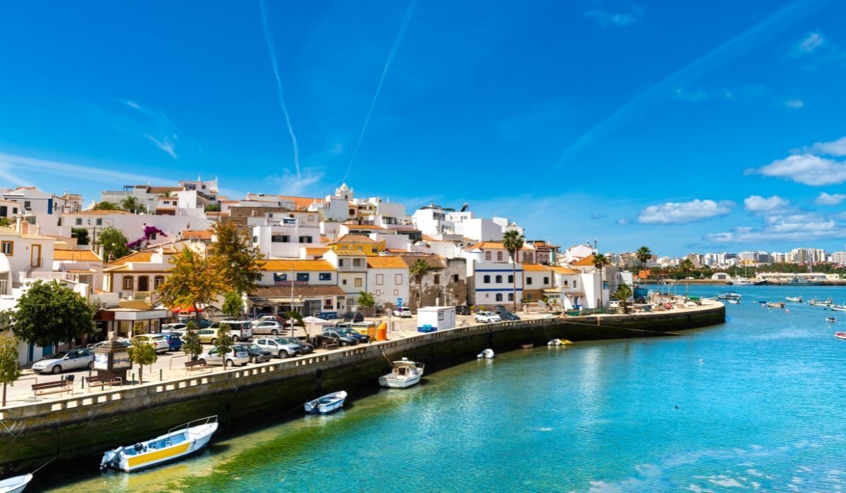Charming waterfront town of Lagos, Portugal with whitewashed buildings and moored fishing boats.