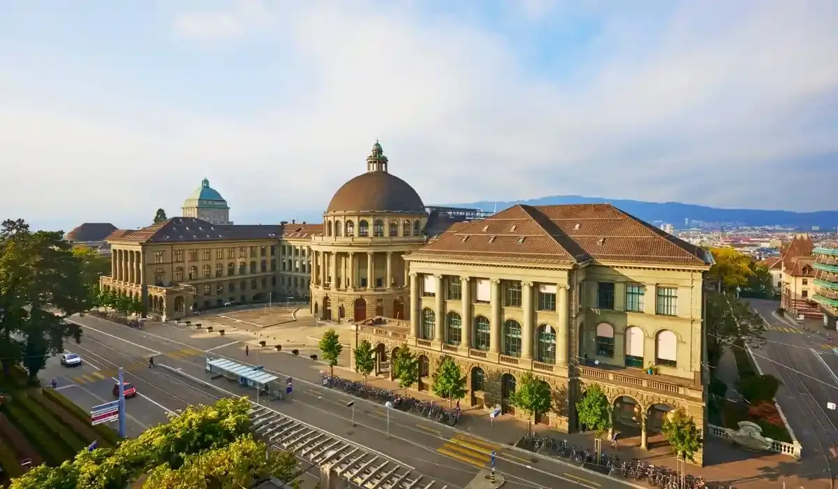 Aerial view of ETH Zurich’s historic main building with a large dome, surrounded by city streets and trams in central Zurich.