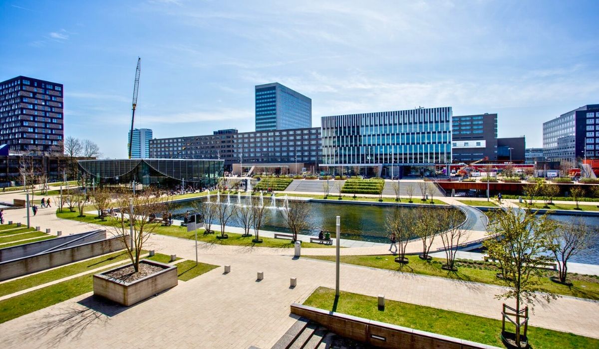 An image capturing Erasmus University Rotterdam's contemporary campus buildings with students.