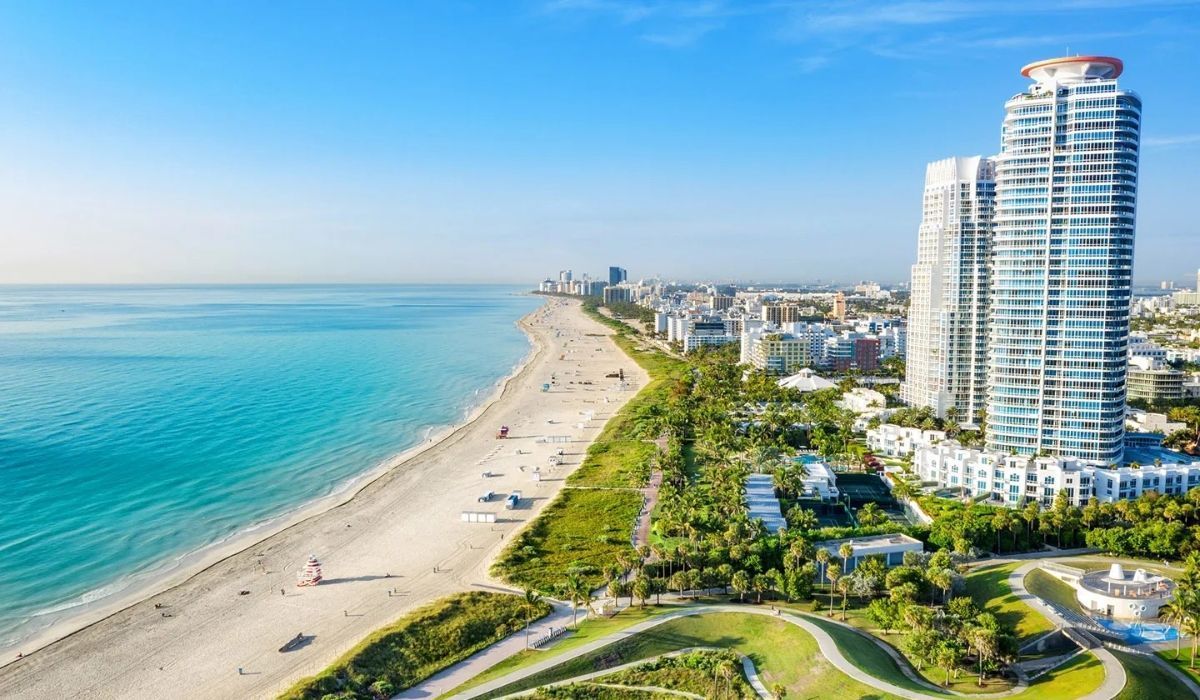 Aerial view of Miami beachfront and high-rise condos along the coast.