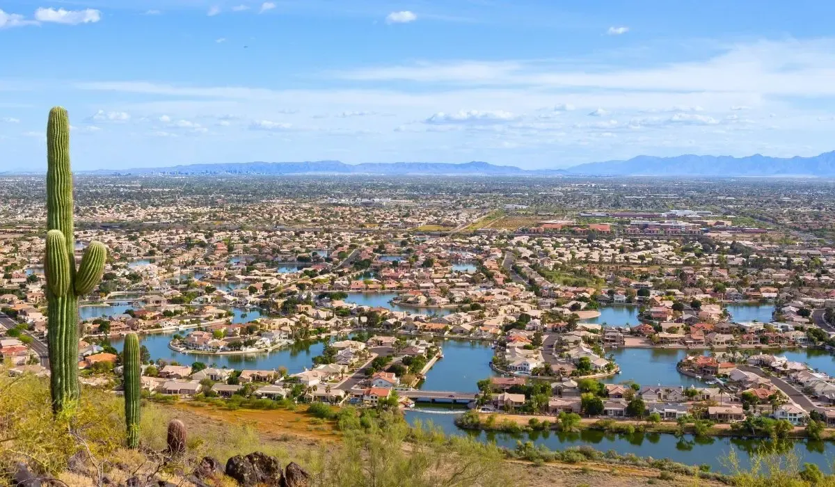 A suburban view of Glendale, highlighting residential neighborhoods with tree-lined streets and the distant backdrop of desert mountains.​