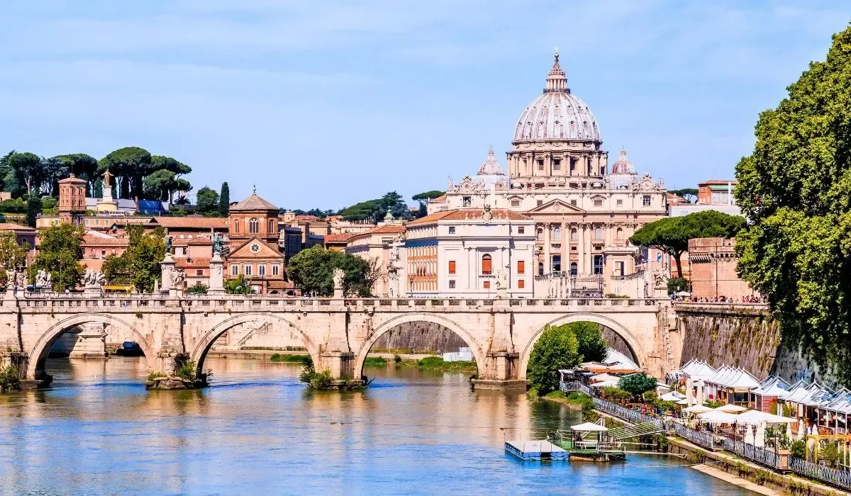 A scenic view of Florence, Italy, highlighting the iconic Duomo cathedral dome rising above the city's terracotta rooftops, with rolling hills in the distance.