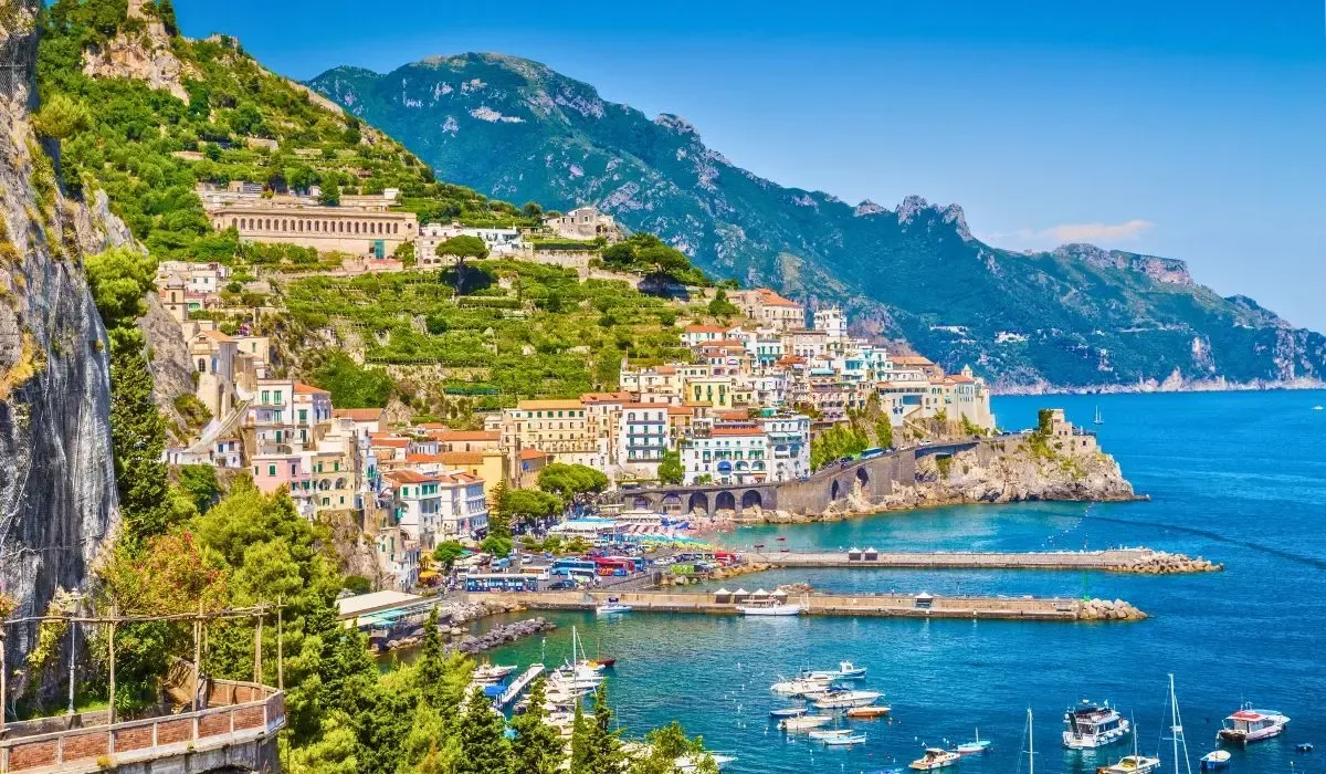 A scenic view of Florence, Italy, highlighting the iconic Duomo cathedral dome rising above the city's terracotta rooftops, with rolling hills in the distance.