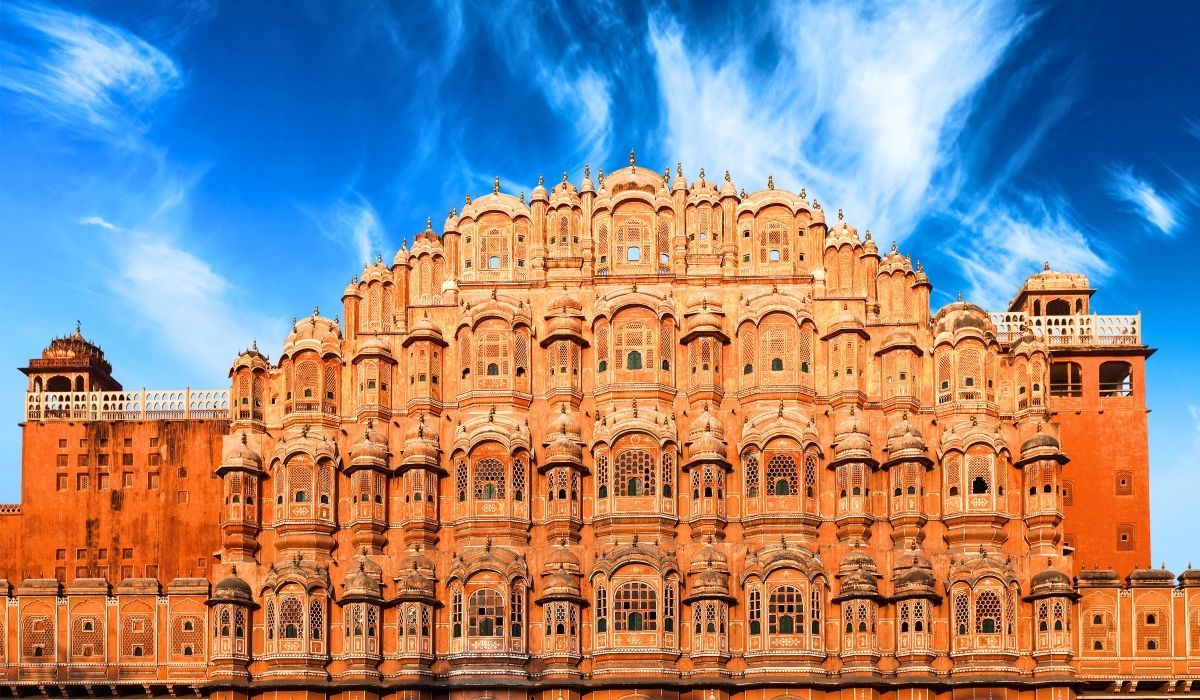 The Hawa Mahal (Palace of Winds) in Jaipur, Rajasthan, with its intricate pink façade under a vivid blue sky.