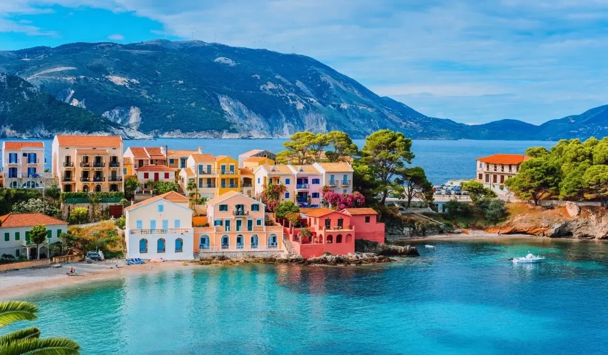 Colorful seaside village of Assos on Kefalonia island, Greece, a popular spot for Canadians purchasing vacation homes and needing cost-effective CAD to EUR currency exchange.