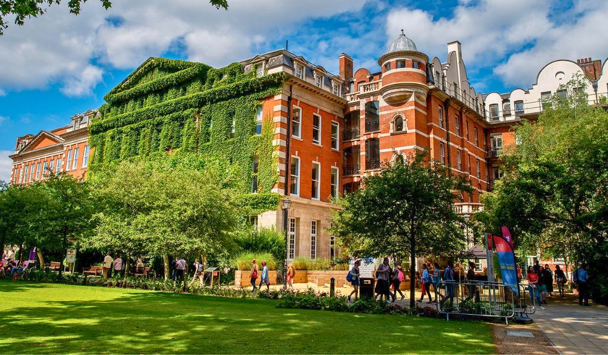 The riverside view of King's College London along the Thames, showcasing historic facades and city surroundings.