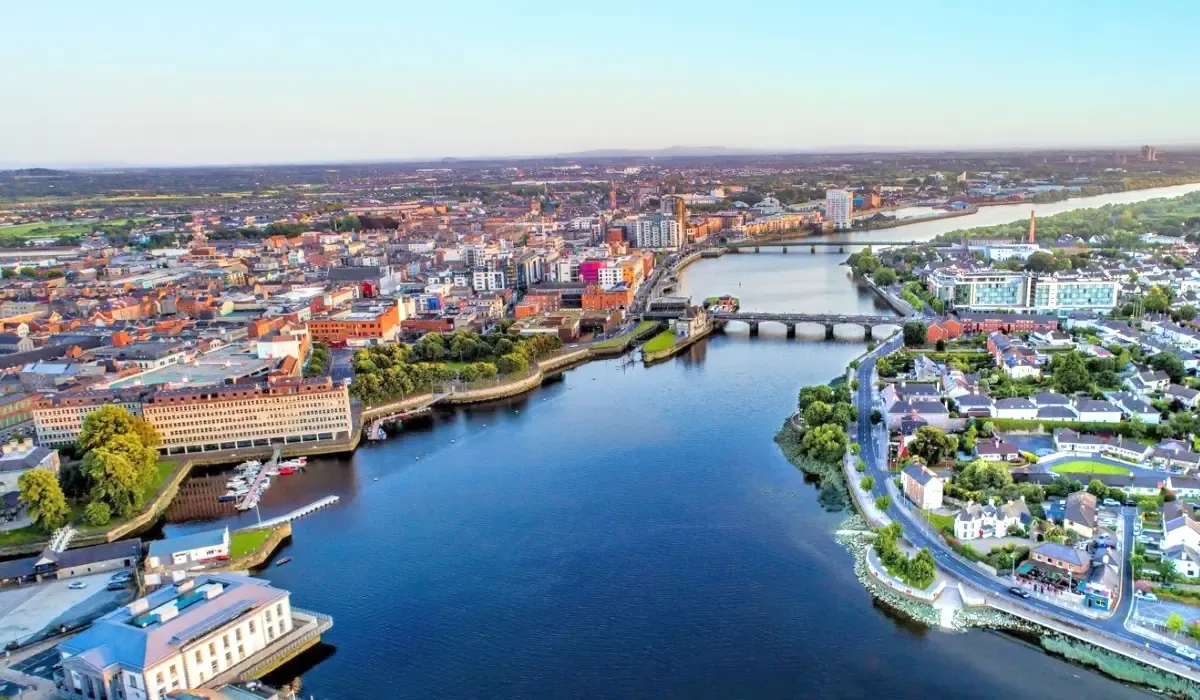 Aerial view of Limerick city and the River Shannon in Ireland under a clear sky. Canadians planning to buy property in Ireland can benefit from competitive CAD to EUR exchange rates and secure money transfers for smooth international real estate transactions.