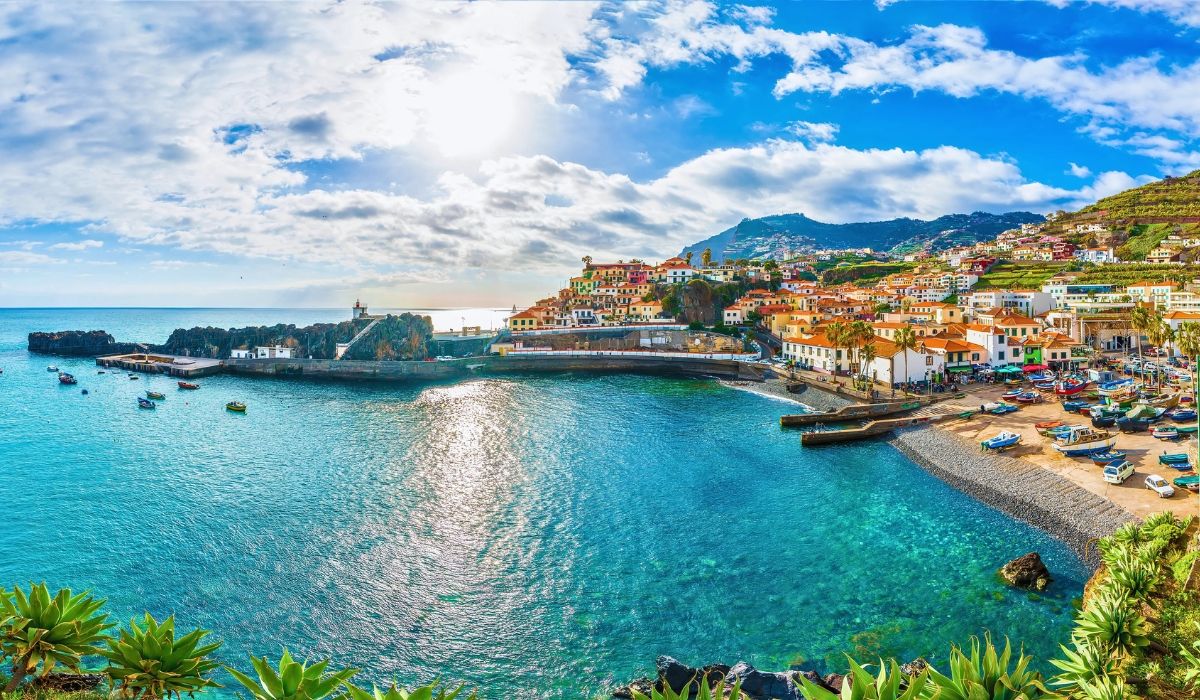 Scenic coastal village and harbor on Madeira Island, Portugal with turquoise waters and hillside homes