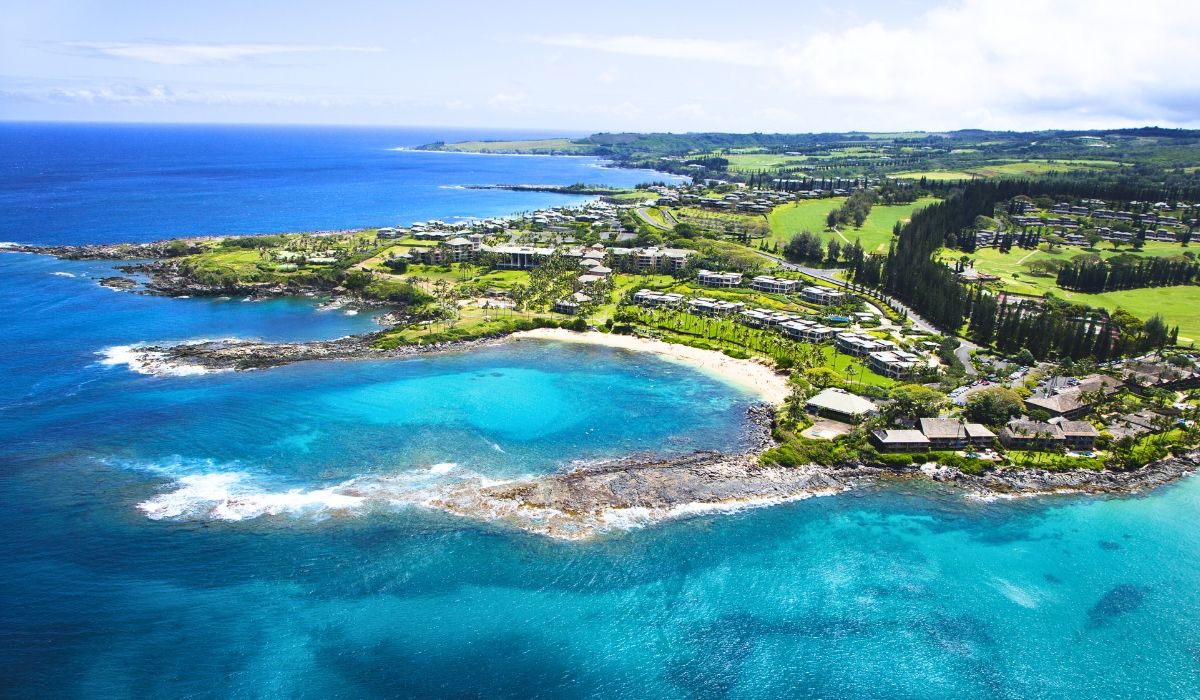 Aerial view of Maui's luxury beachfront properties, golf courses, and turquoise bays.