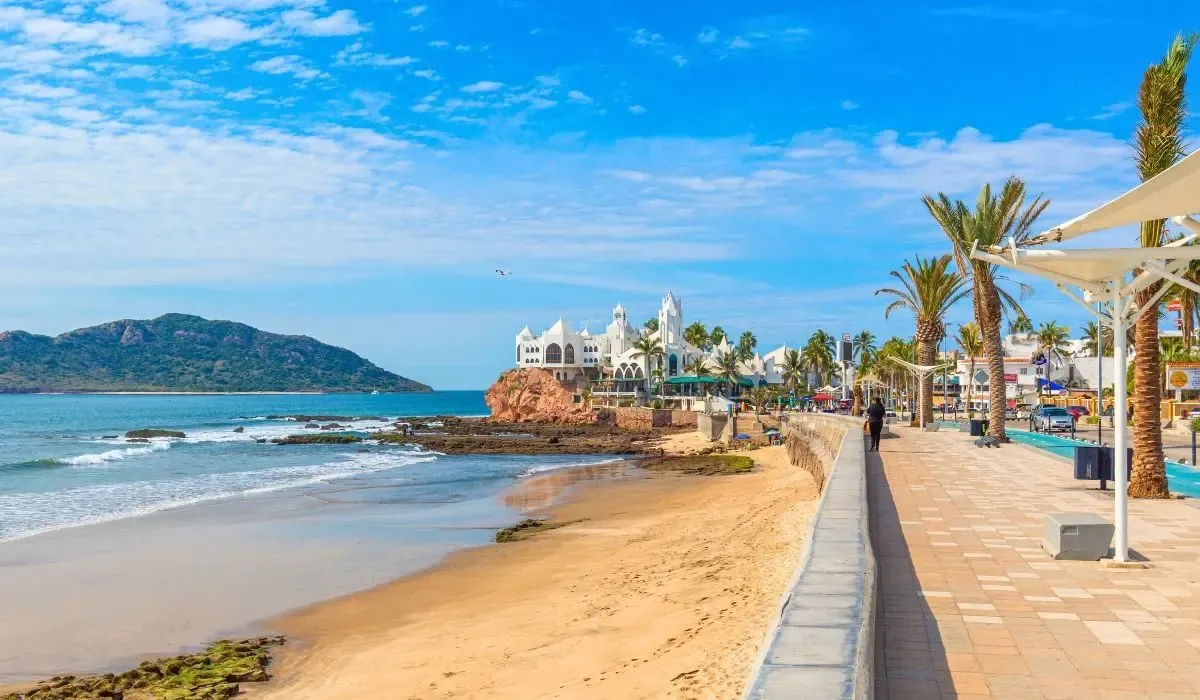Scenic walkway along Mazatlan’s golden beach and ocean views, representing an appealing spot for Canadians buying Mexican vacation homes with reliable foreign exchange and money transfer solutions.