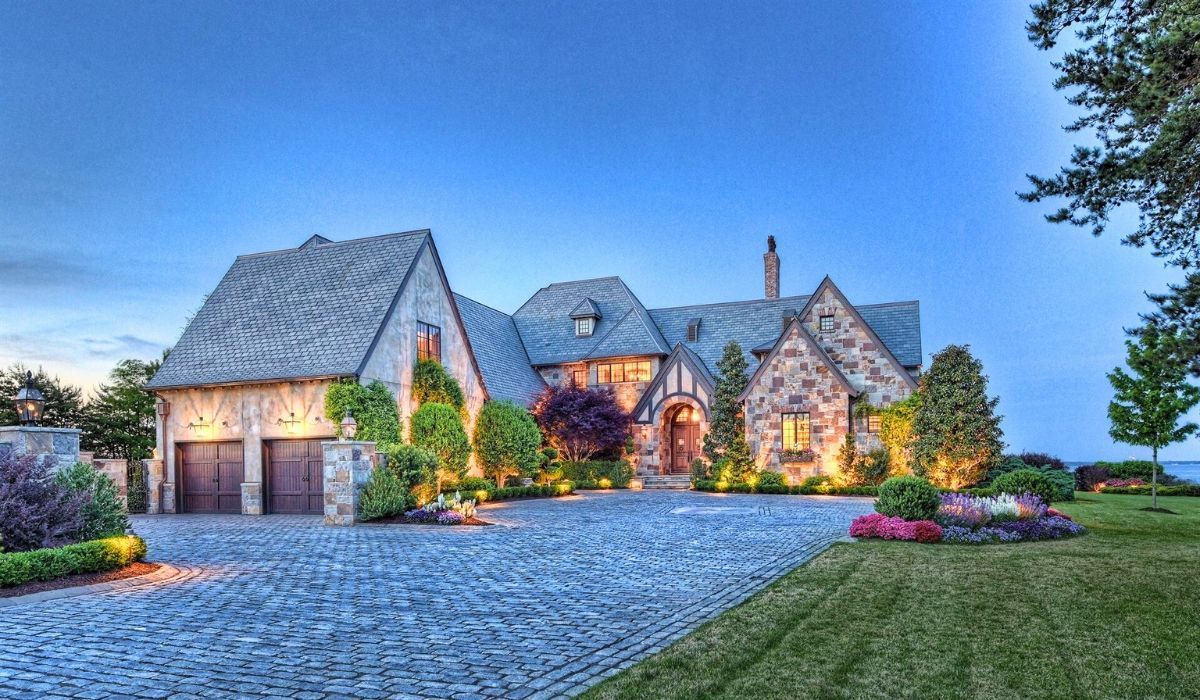 Grand estate home in North Carolina with evening lighting and landscaped entrance.