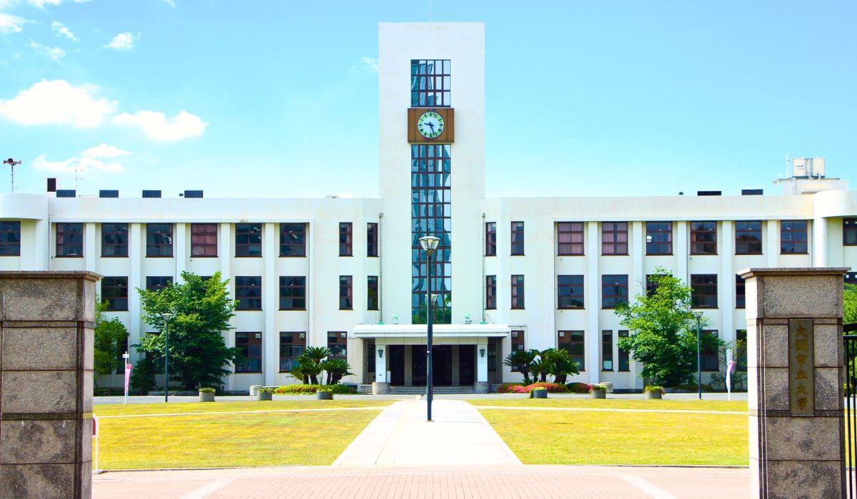 An aerial shot of Osaka University's campus, highlighting modern academic buildings interspersed with green spaces and walkways.