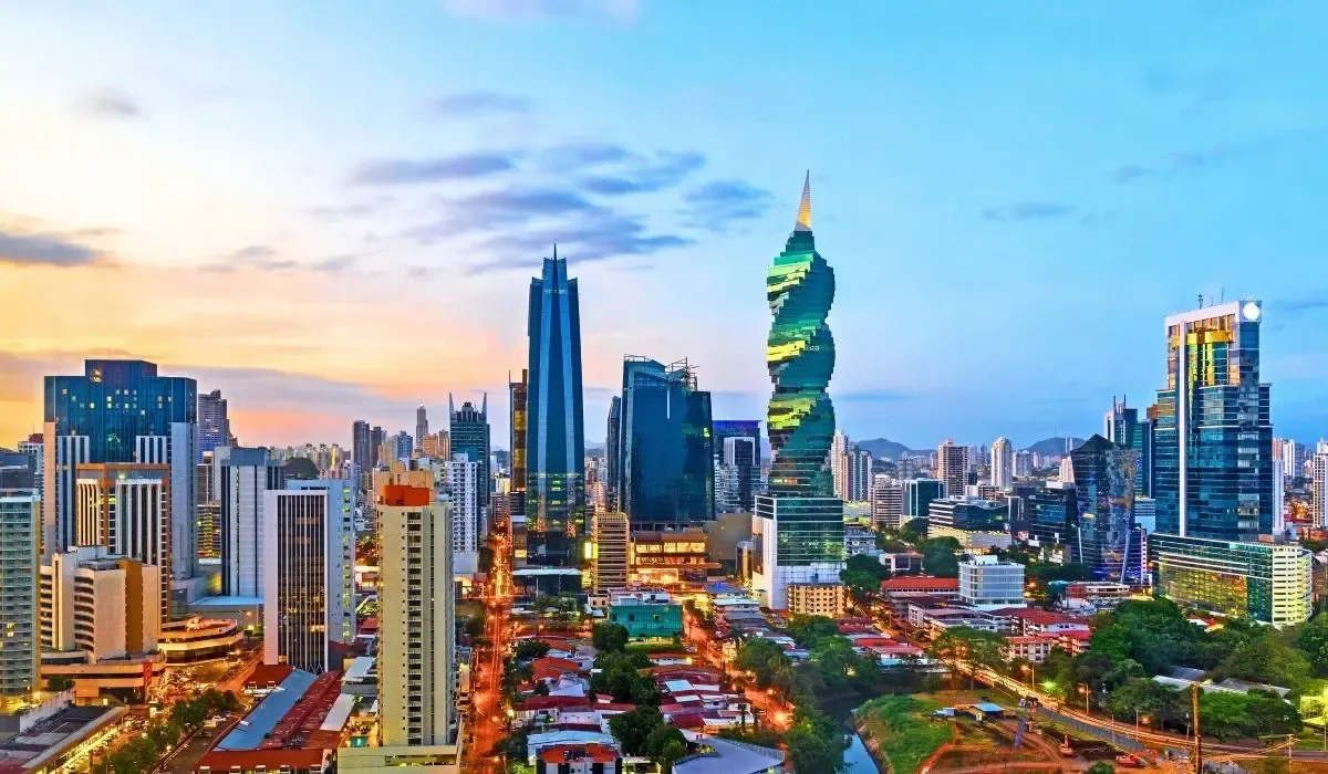 Cityscape of Panama City, Panama with a modern skyline including the iconic twisted F&F Tower against a sunset sky. Canadians looking to buy property in Panama can leverage strong CAD to USD rates and lower fees on international transactions using MTFX.