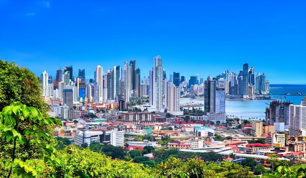 Panama City skyline with modern skyscrapers and Pacific coastline, highlighting opportunities for Canadians buying property abroad and securing better CAD to USD exchange rates and low-fee international money transfers with MTFX.