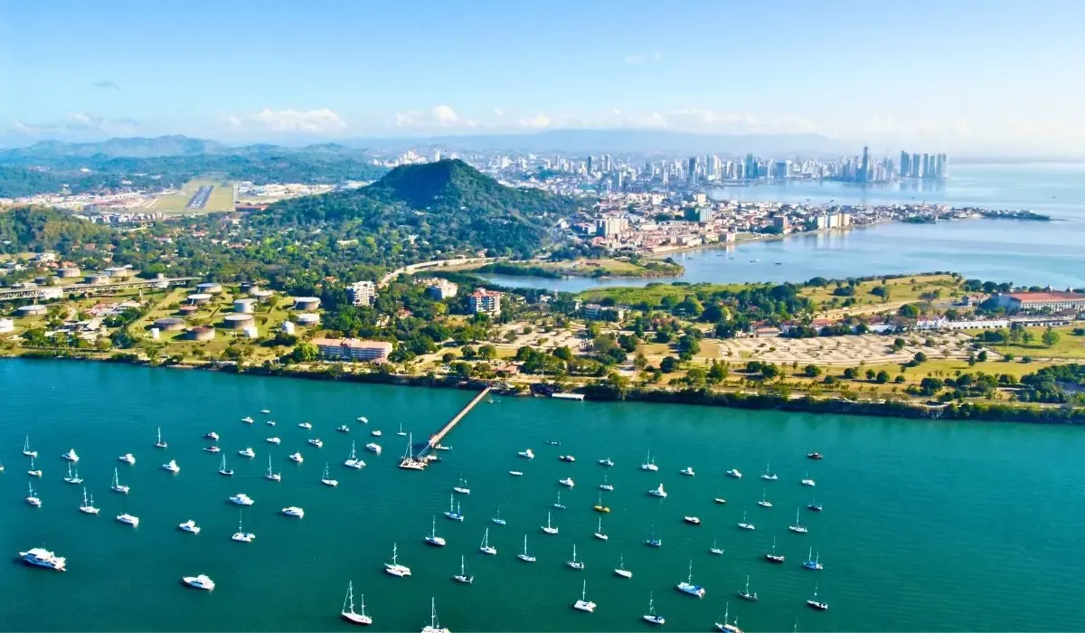 An urban skyline of Panama City, featuring modern skyscrapers juxtaposed against the historic Casco Viejo district along the waterfront.​