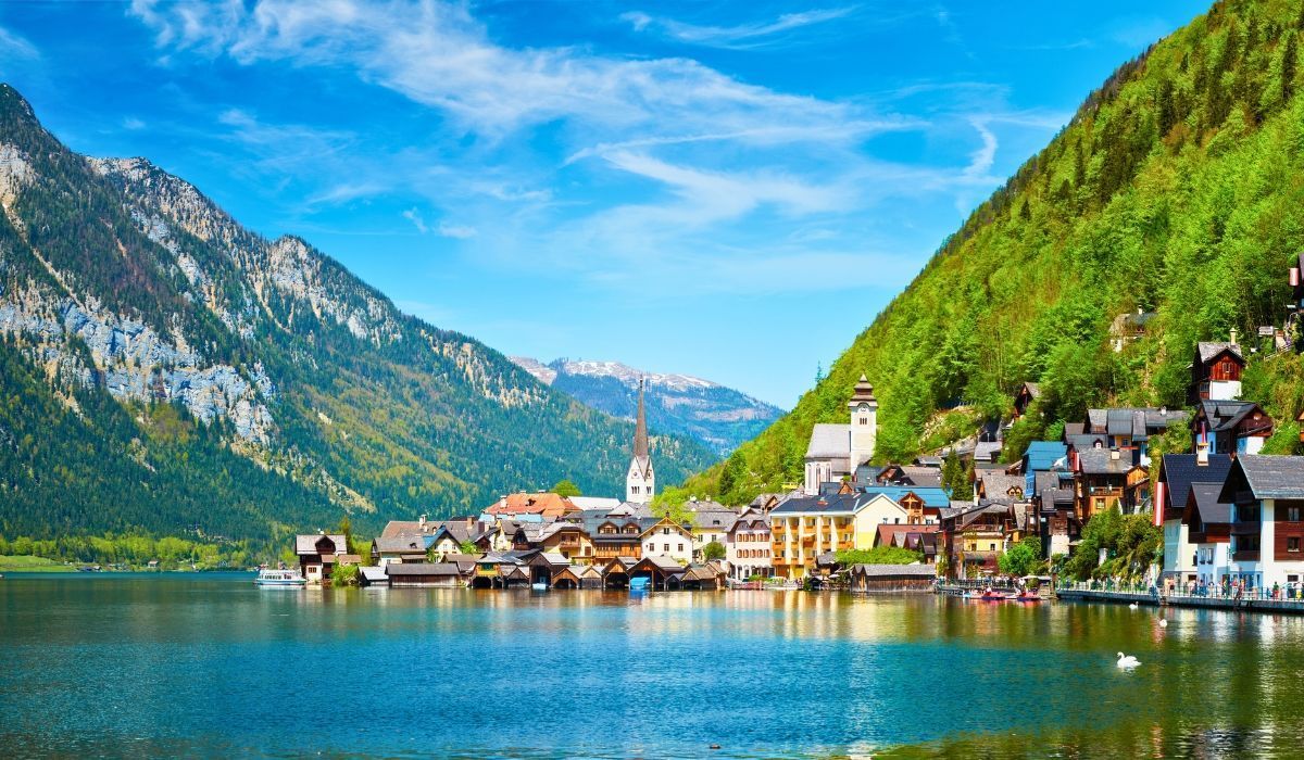 Scenic alpine village of Hallstatt, Austria nestled between a lake and green mountains.