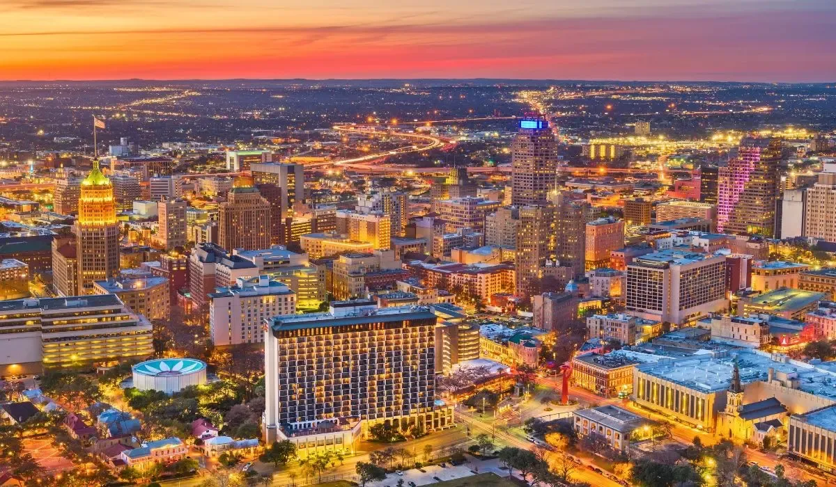 A vibrant image of San Antonio, Texas, highlighting the historic Alamo mission and the bustling River Walk lined with cafes and shops.