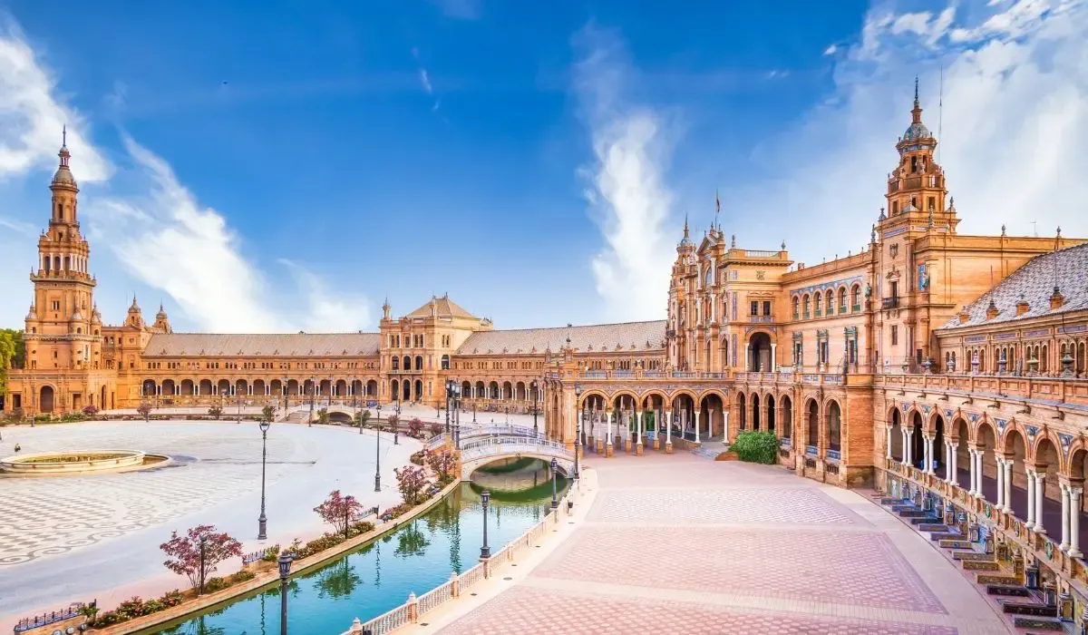 The Plaza de España in Seville with its iconic towers and canal under a clear sky. MTFX helps Canadian students studying in Spain save on tuition transfers with fast service and better EUR rates.