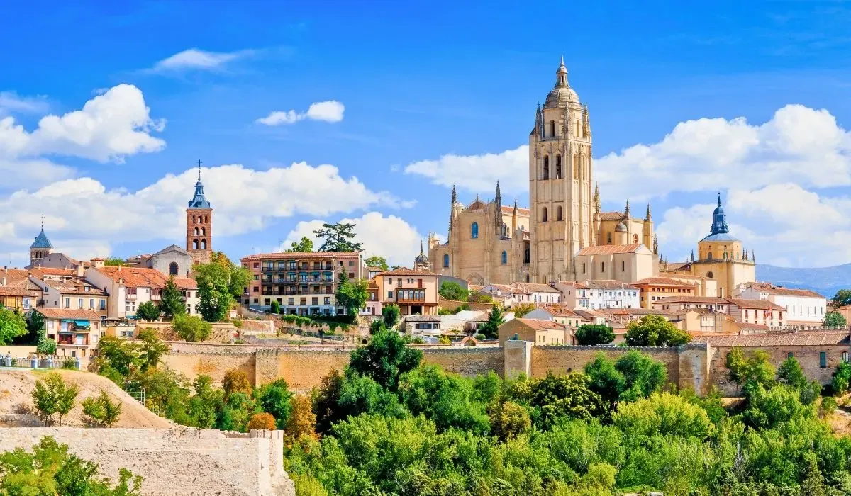 A vibrant street scene in Barcelona, Spain, featuring the colorful facades of buildings along La Rambla, bustling with pedestrians and street performers.