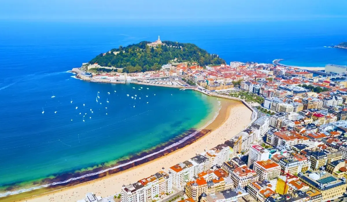A vibrant street scene in Barcelona, Spain, featuring the colorful facades of buildings along La Rambla, bustling with pedestrians and street performers.