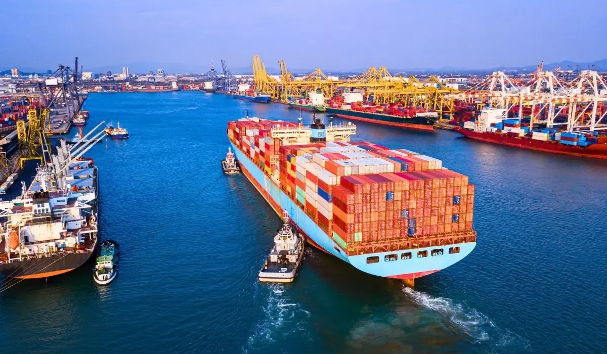 A cargo ship at sea loaded with shipping containers, symbolizing international trade and overseas supplier payments.