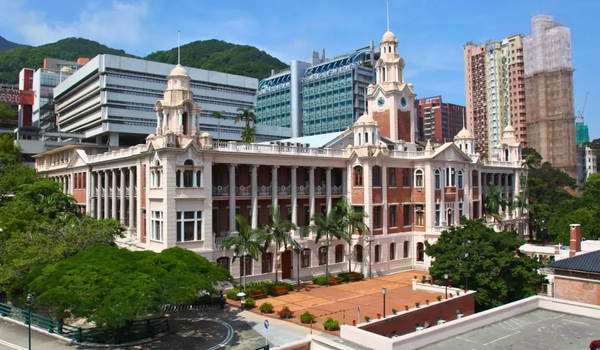 The Main Building of the University of Hong Kong, characterized by its colonial-era architecture and surrounding palm trees.